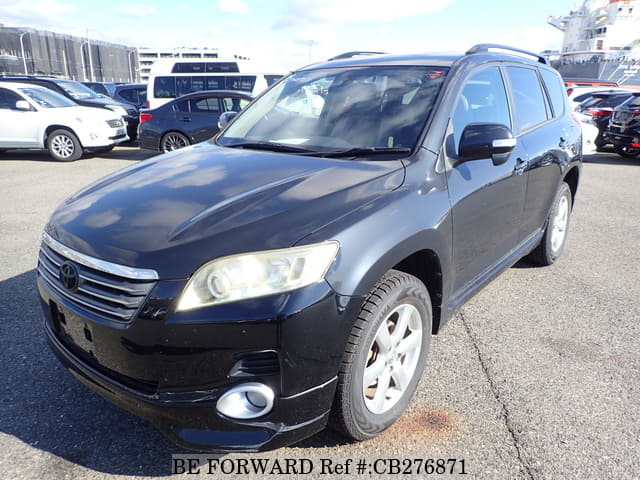 A grey JDM sports car speeding down a highway at night.