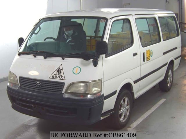 A grey JDM sports car speeding down a highway at night.