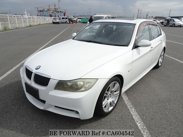 A grey JDM sports car speeding down a highway at night.