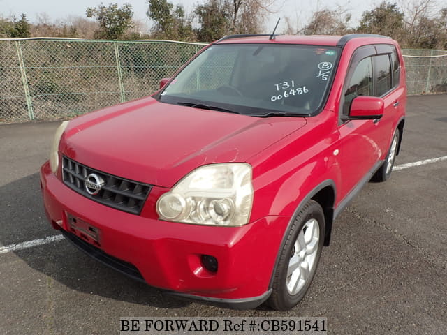 A grey JDM sports car speeding down a highway at night.