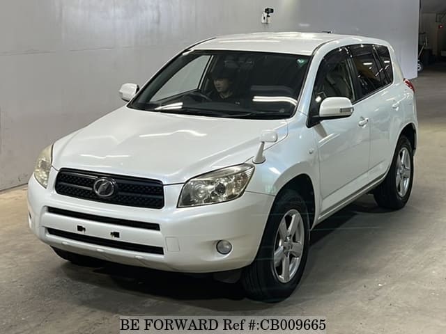 A grey JDM sports car speeding down a highway at night.