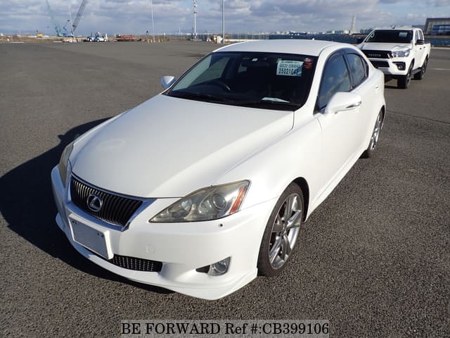 A grey JDM sports car speeding down a highway at night.