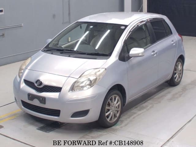 A grey JDM sports car speeding down a highway at night.