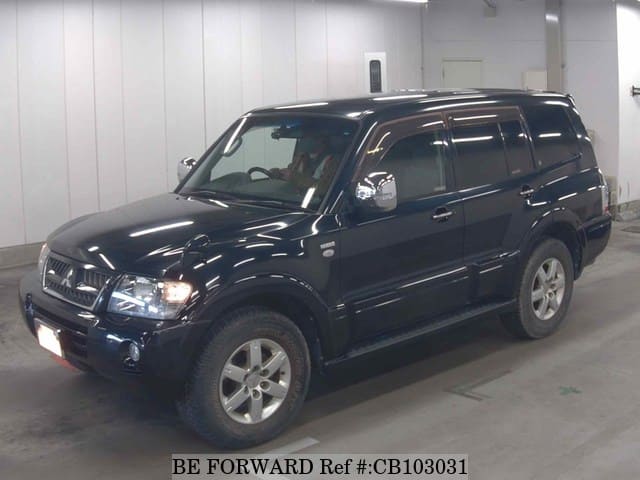 A grey JDM sports car speeding down a highway at night.