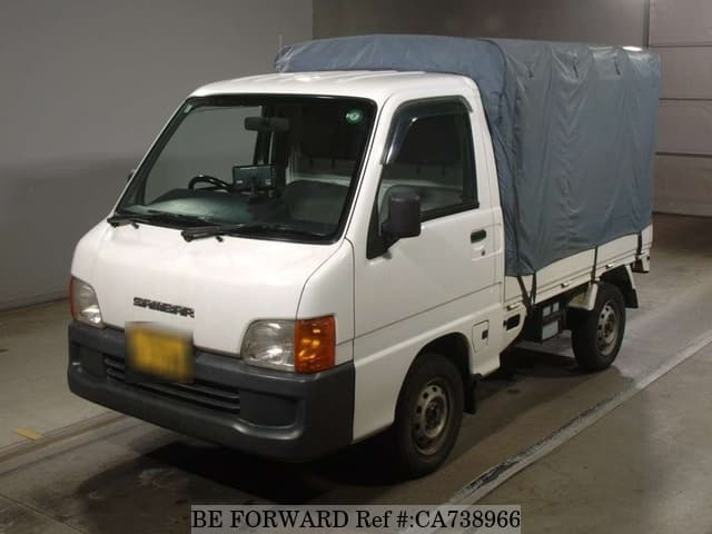 A grey JDM sports car speeding down a highway at night.