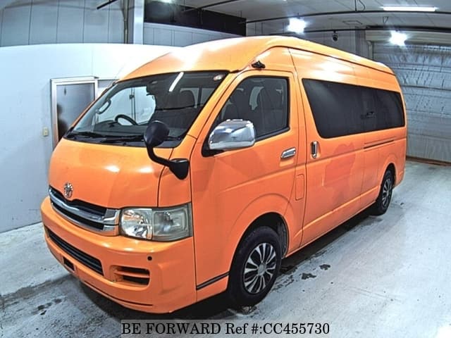 A grey JDM sports car speeding down a highway at night.