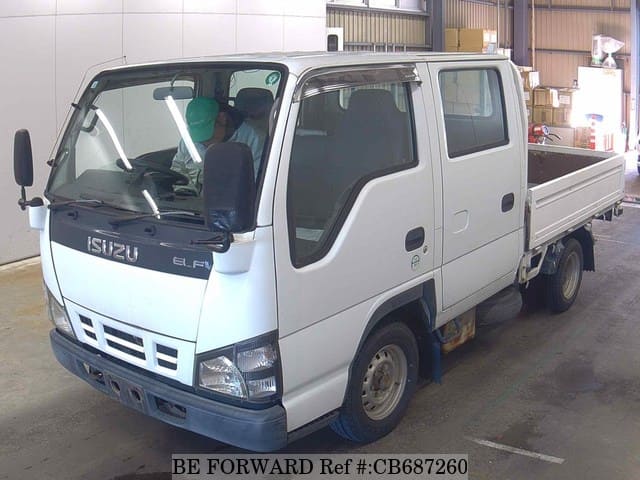 A grey JDM sports car speeding down a highway at night.