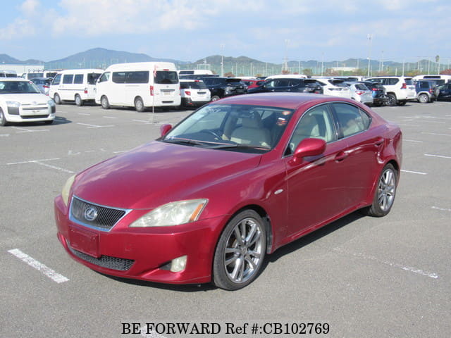 A grey JDM sports car speeding down a highway at night.