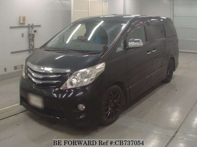 A grey JDM sports car speeding down a highway at night.