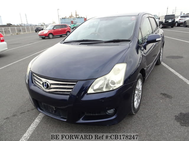 A grey JDM sports car speeding down a highway at night.