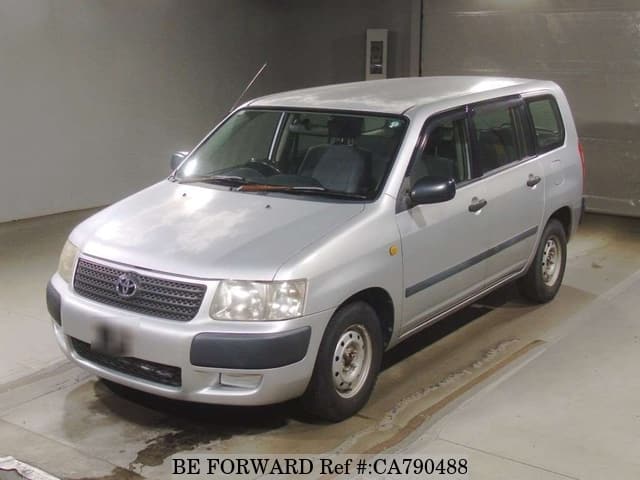 A grey JDM sports car speeding down a highway at night.