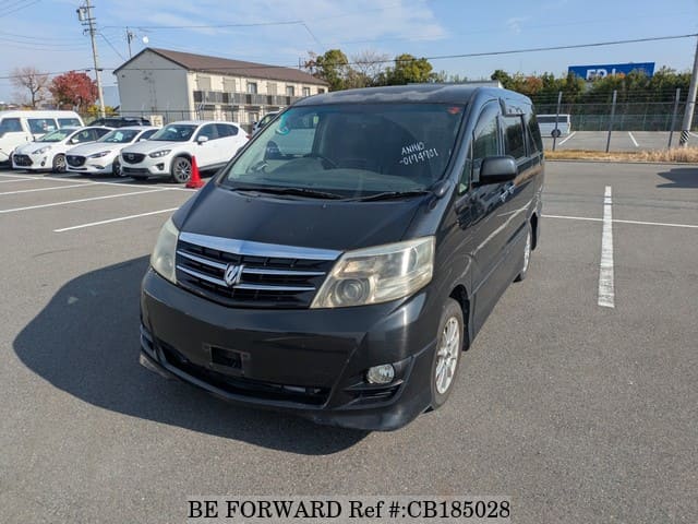 A grey JDM sports car speeding down a highway at night.