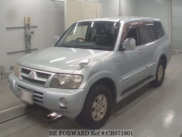 A grey JDM sports car speeding down a highway at night.