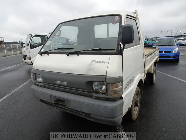 A grey JDM sports car speeding down a highway at night.