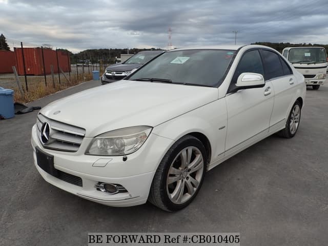 A grey JDM sports car speeding down a highway at night.