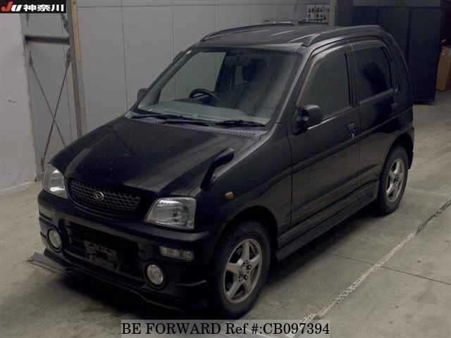 A grey JDM sports car speeding down a highway at night.