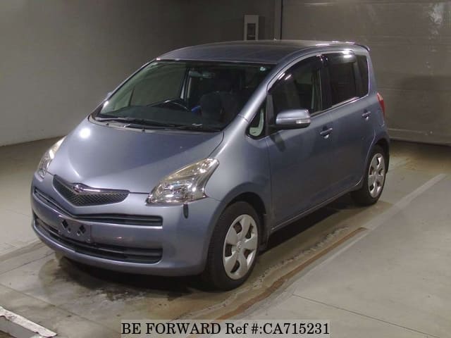 A grey JDM sports car speeding down a highway at night.