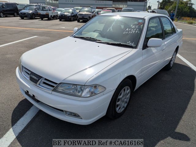 A grey JDM sports car speeding down a highway at night.