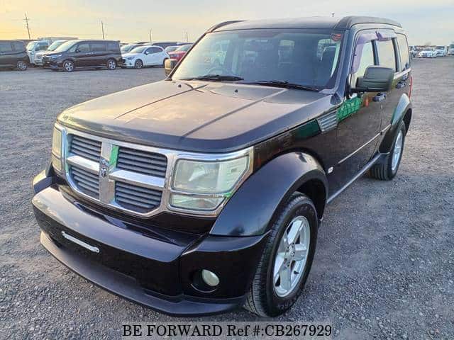 A grey JDM sports car speeding down a highway at night.