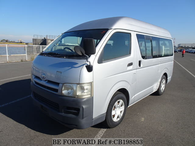 A grey JDM sports car speeding down a highway at night.