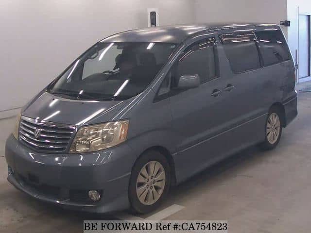 A grey JDM sports car speeding down a highway at night.