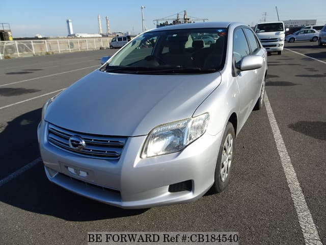 A grey JDM sports car speeding down a highway at night.