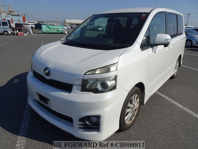 A grey JDM sports car speeding down a highway at night.