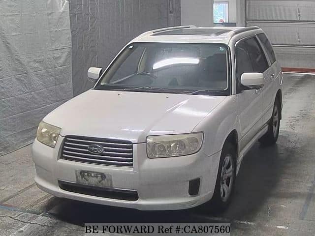 A grey JDM sports car speeding down a highway at night.
