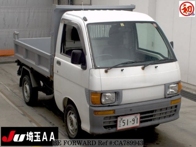 A grey JDM sports car speeding down a highway at night.