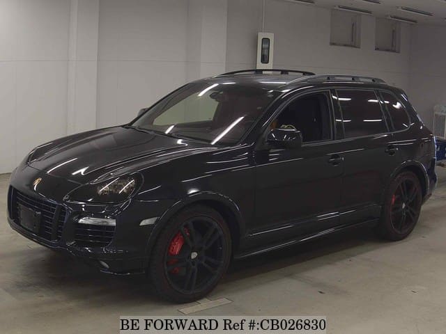 A grey JDM sports car speeding down a highway at night.