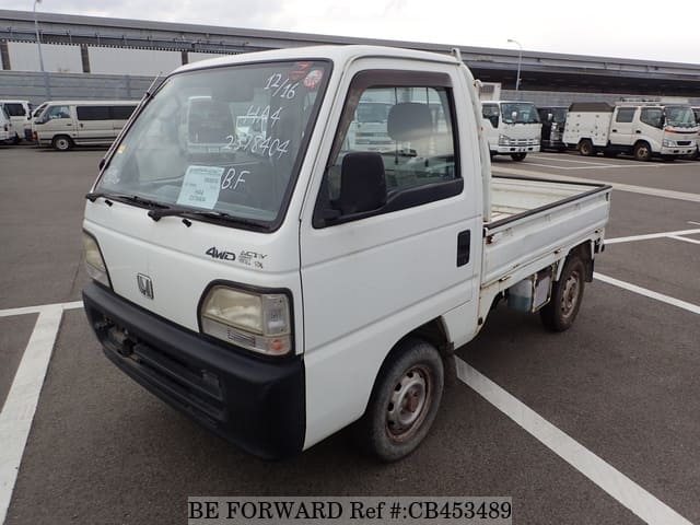 A grey JDM sports car speeding down a highway at night.