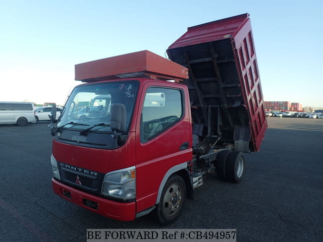 A grey JDM sports car speeding down a highway at night.