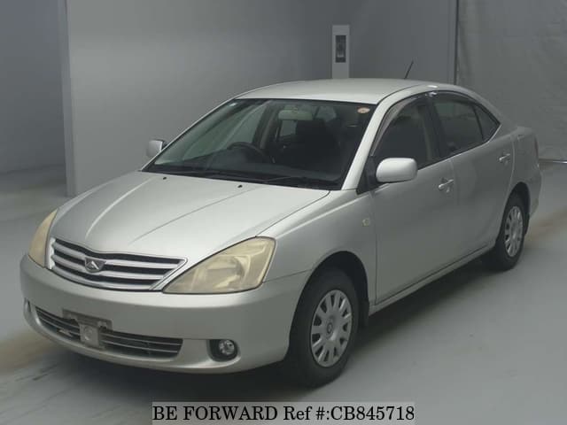 A grey JDM sports car speeding down a highway at night.