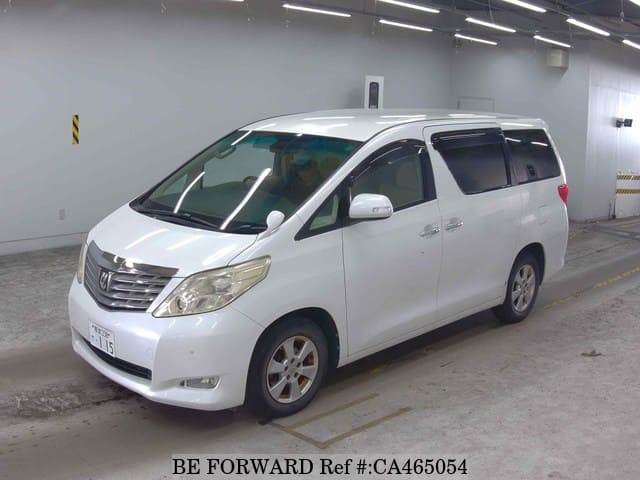 A grey JDM sports car speeding down a highway at night.