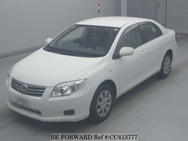 A grey sports car speeding down a highway at night.