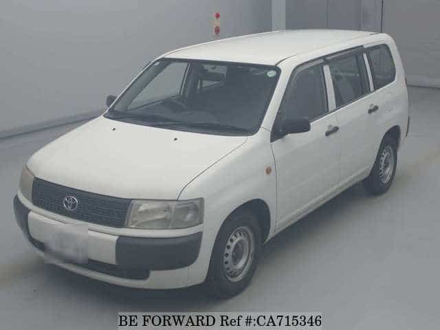 A grey JDM sports car speeding down a highway at night.