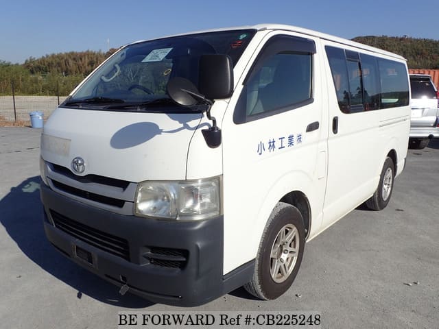 A grey JDM sports car speeding down a highway at night.