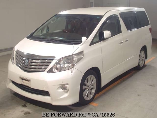 A grey JDM sports car speeding down a highway at night.