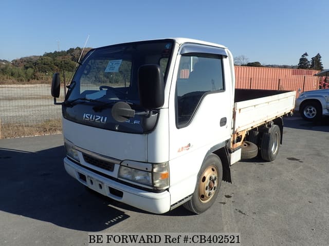 A grey JDM sports car speeding down a highway at night.