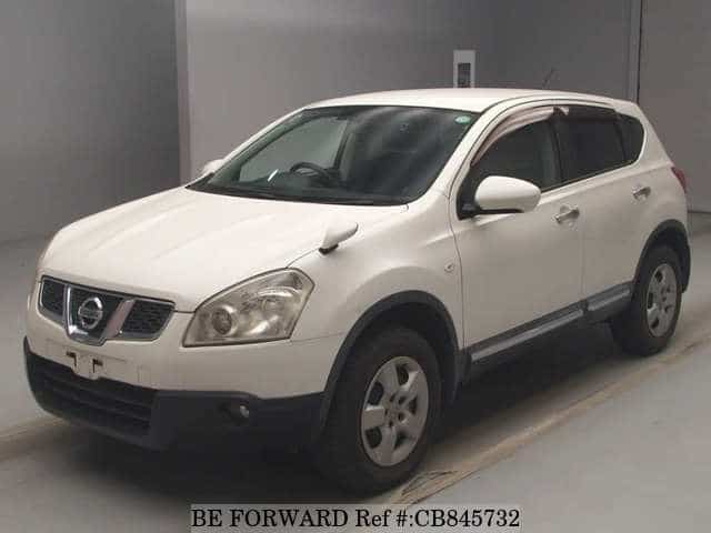 A grey JDM sports car speeding down a highway at night.