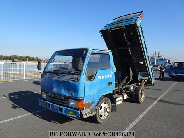 A grey JDM sports car speeding down a highway at night.