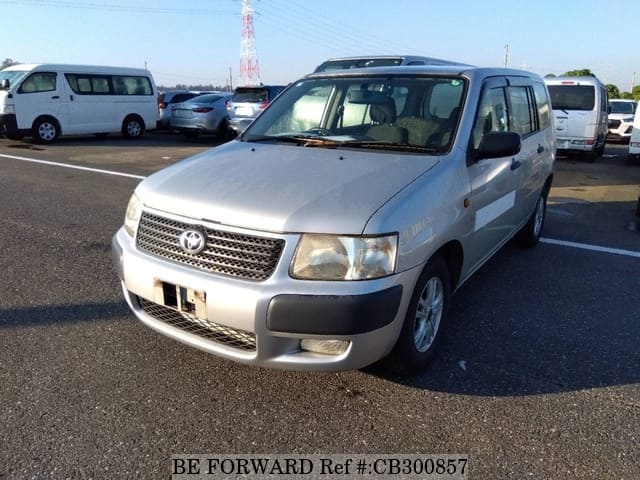 A grey JDM sports car speeding down a highway at night.