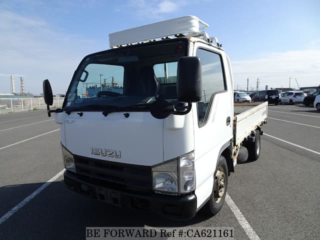 A grey JDM sports car speeding down a highway at night.