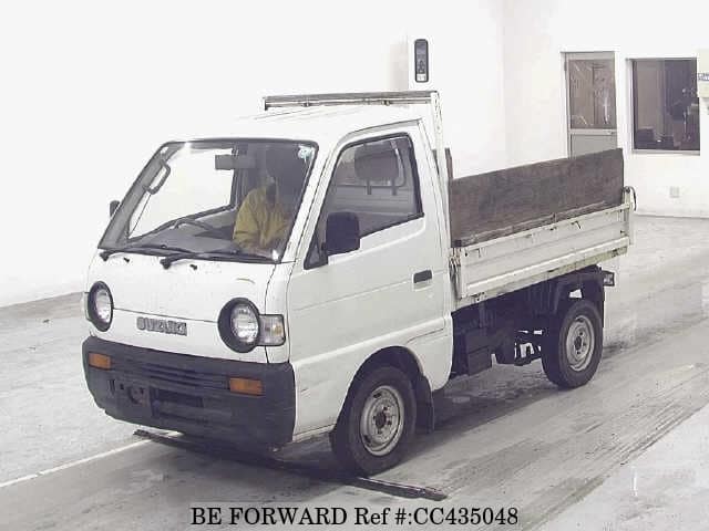 A grey JDM sports car speeding down a highway at night.