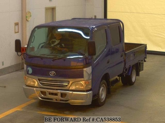 A grey JDM sports car speeding down a highway at night.