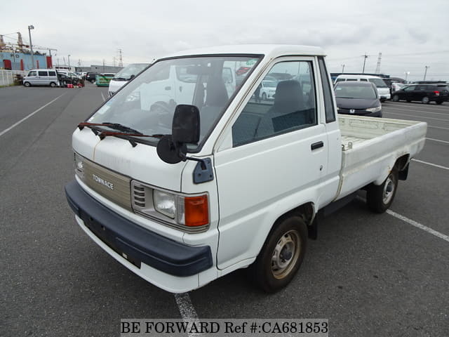 A grey JDM sports car speeding down a highway at night.