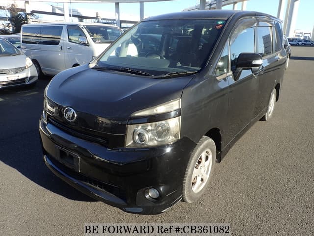 A grey JDM sports car speeding down a highway at night.