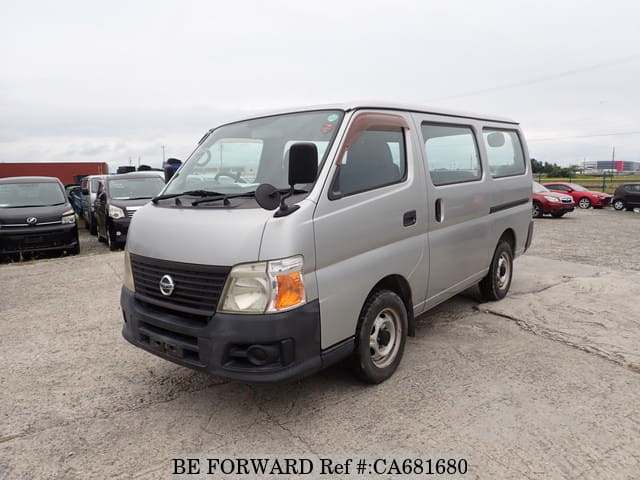 A grey JDM sports car speeding down a highway at night.