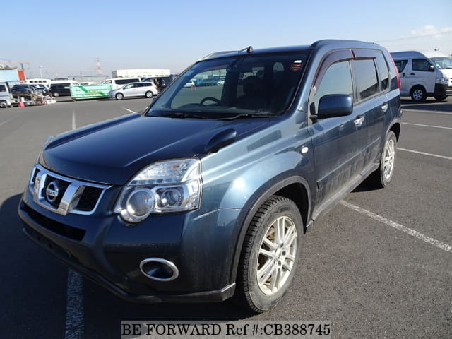A grey JDM sports car speeding down a highway at night.