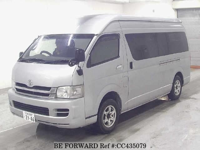 A grey JDM sports car speeding down a highway at night.